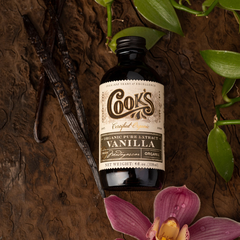 Organic Pure Madagascar Vanilla Extract on Wood with a Vanilla Flower and Beans | Cook's Flavoring Company | Vanilla Beans & Extracts @ Spice Craze®