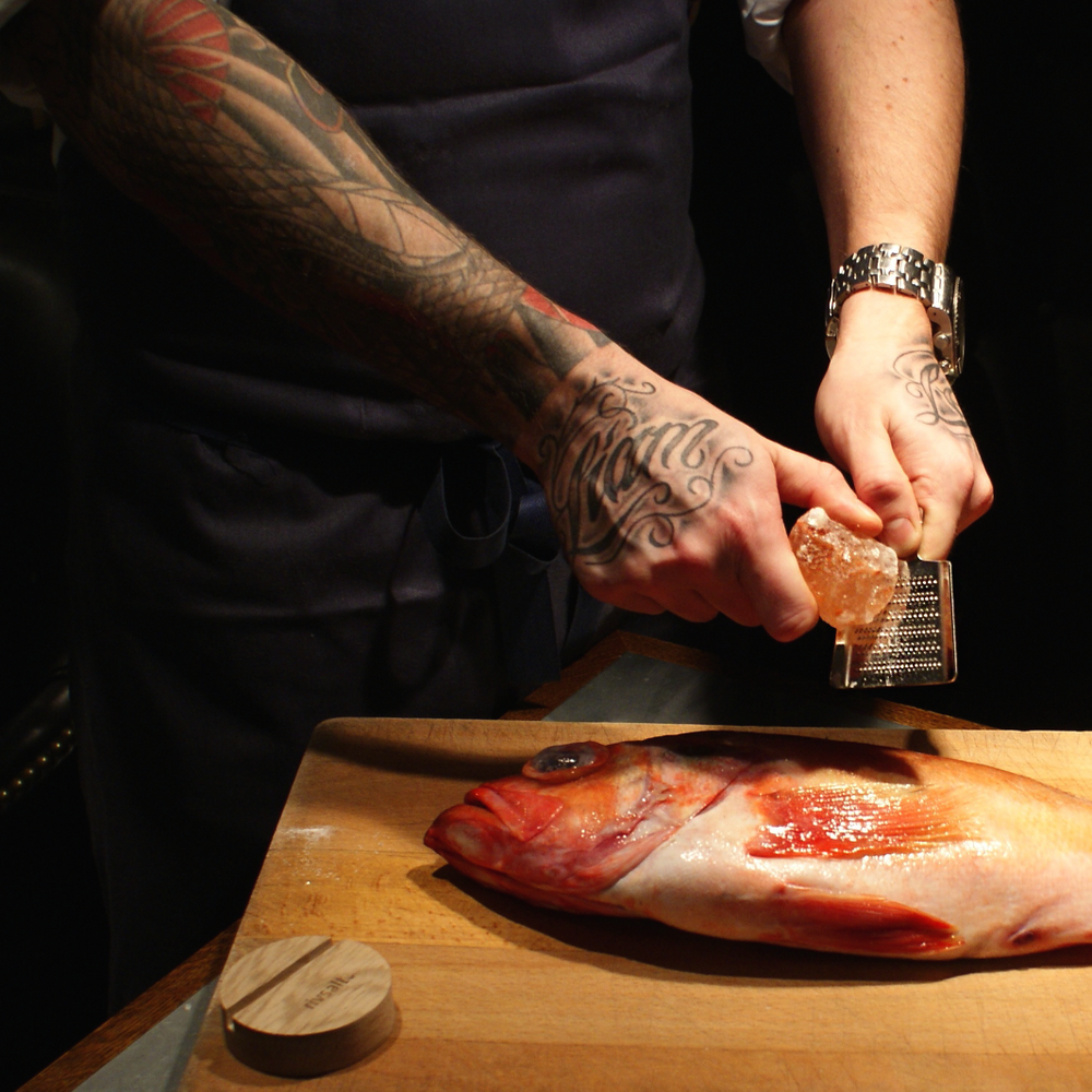 Man Seasoning Fish with RIVSALT™ Original Himalayan Rock Salt Gift Set | RIVSALT™ Scandinavian design for foodies | Grate, Strip, & Zest @ Spice Craze®