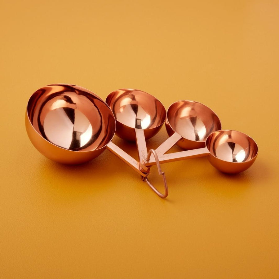 Set of 4 Acadia Copper Measuring Cups on a Mustard Background | Be Home US | Measuring & Mixing @ Spice Craze®