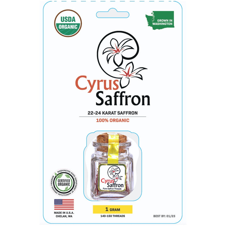 Cyrus Saffron 1 gram of organic saffron in a clear glass jar with a cork stopper and yellow ribbon, presented on its retail blister card packaging with USDA Organic and Washington state grown badges.