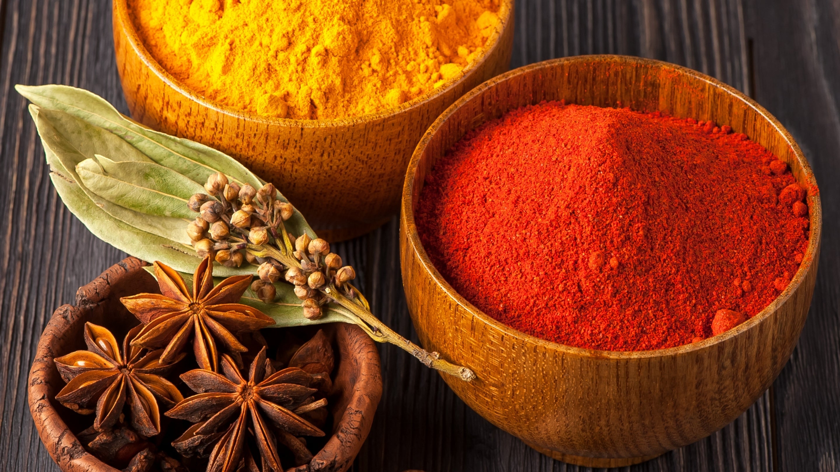 Spice Craze™ Home Page Photo | Three Wooden Bowls Filled with Various Spices