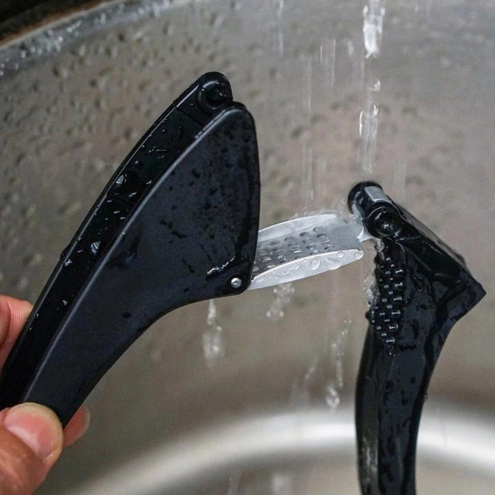 Jona's Easy-Clean Garlic Press Being Rinsed with Water | RSVP International | Prepping & Cooking @ Spice Craze®