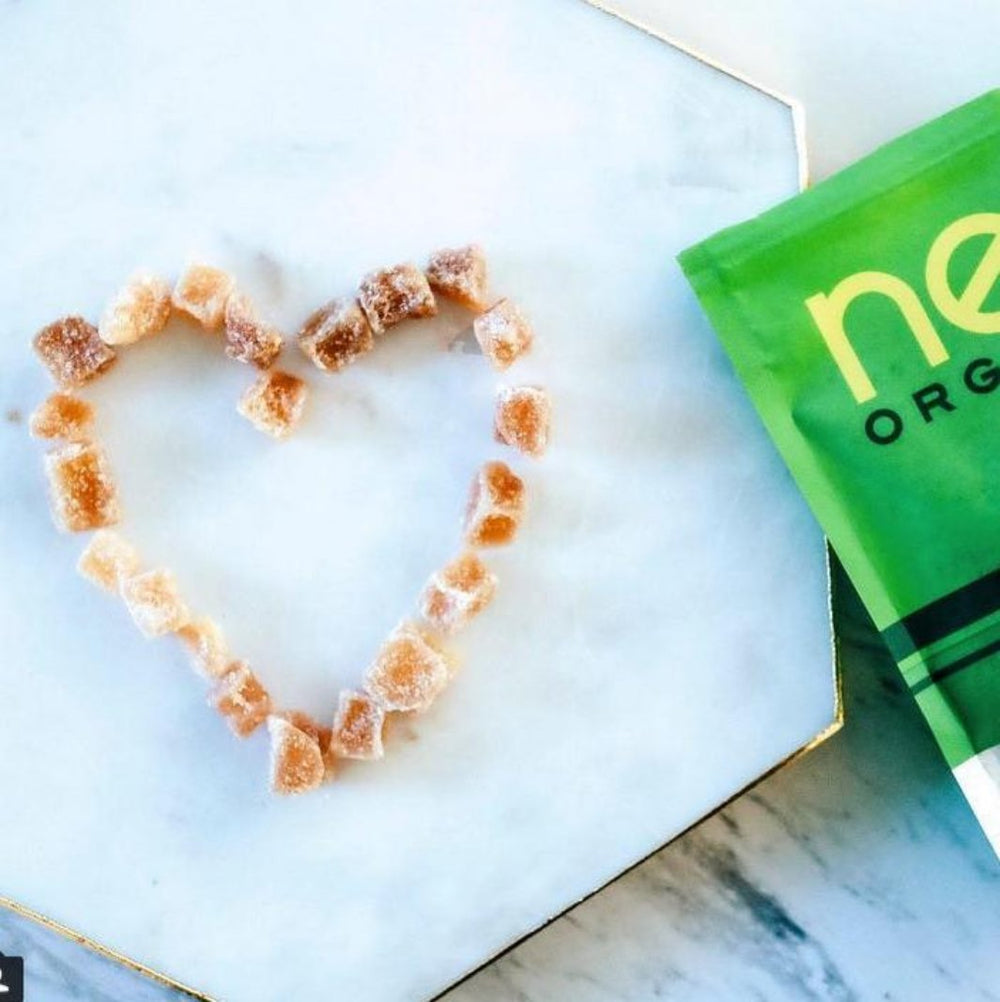Cubes of Organic Crystallized Ginger Arranged in a Heart Shape Next to Bag | Next Organics™ | The Sweeter Side @ Spice Craze®