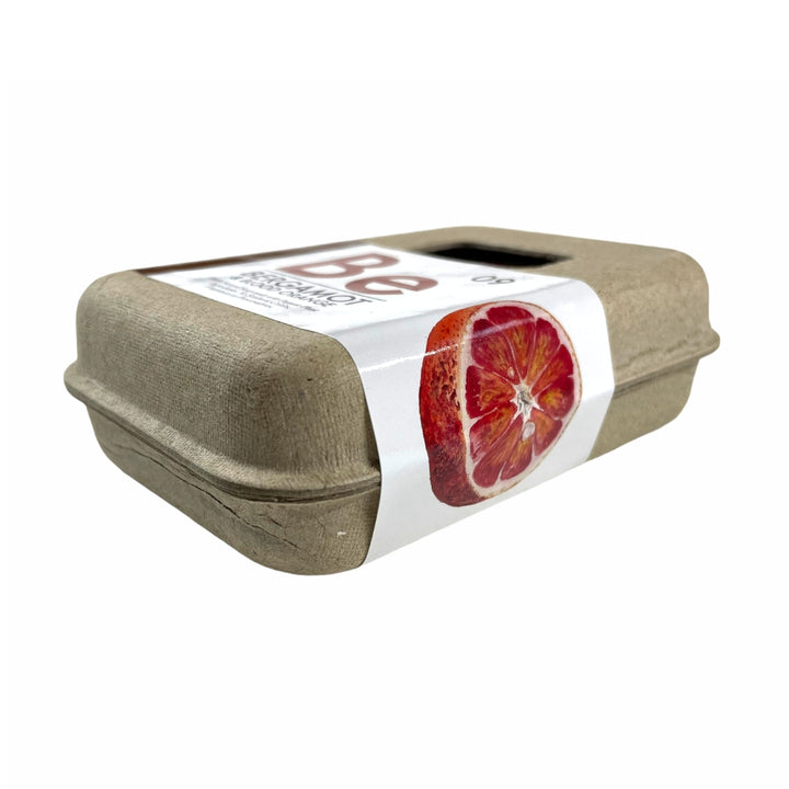 Side view of Organic Bergamot & Blood Orange Soap made by Seattle Seed Co. in eco-friendly egg-carton-like packaging with a white label with blood orange picture | Camping & Garden @ Spice Craze®