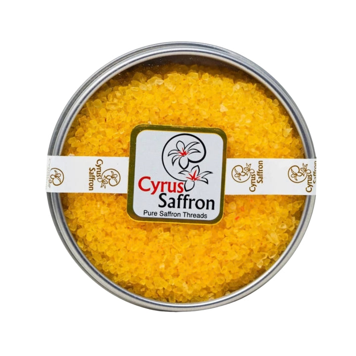 3 oz of Saffron Sea Salt in a metal tin with a white band from Cyrus Saffron containing organic saffron grown in Washington State combined with sea salt, giving it a bright yellow color
