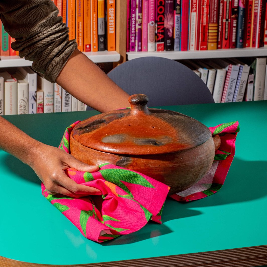 Pink Spicy Dish Towel being Used to Carry a Pot | Diaspora Co. | Aprons & Linens @ Spice Craze®