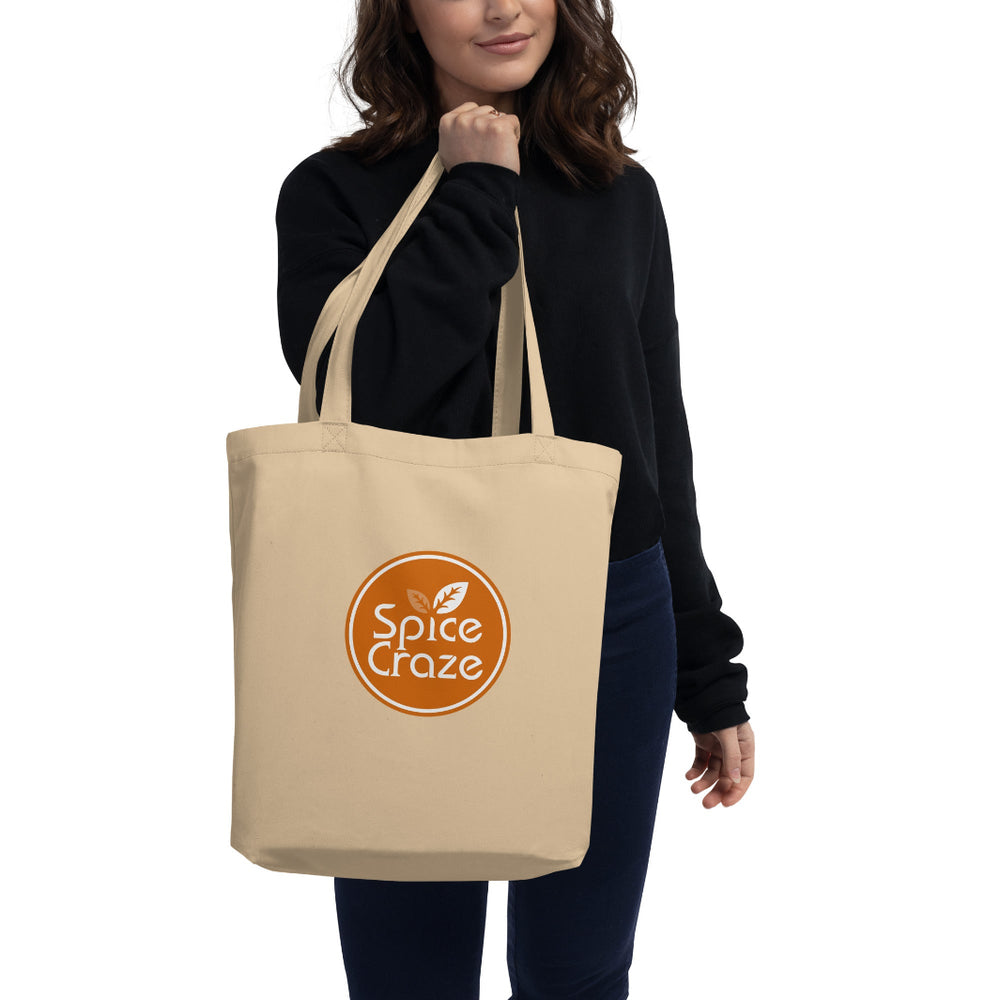 Person Holding an Orange-Colored Logo Eco Tote Bag | Spice Craze® Merch @ Spice Craze®