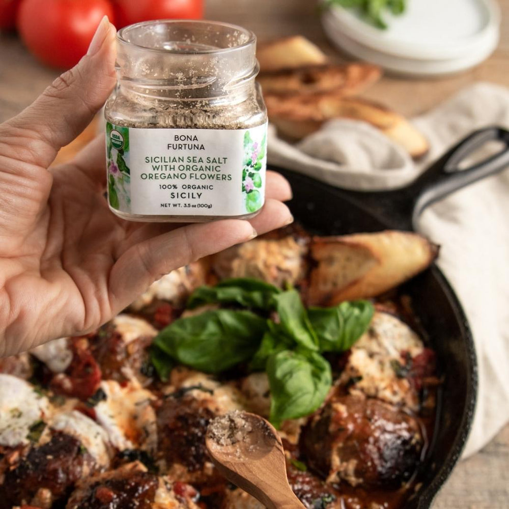 Sicilian Sea Salt with Organic Oregano Flowers being Sprinkled on a Dish | Bona Furtuna | Specialty Salts @ Spice Craze®
