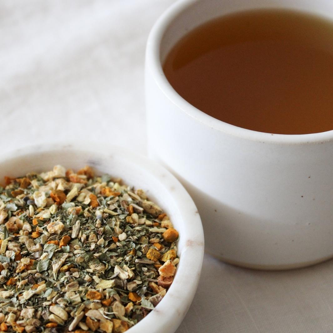 Turmeric & Ginger - Organic Herbal Tea in a Bowl with a Cup of Tea | Nuda Botanica | Matcha, Chai, & Tea @ Spice Craze®
